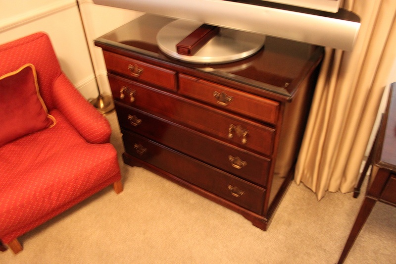 A Georgian style mahogany chest of drawers with three full and two half drawers on bracket plinth