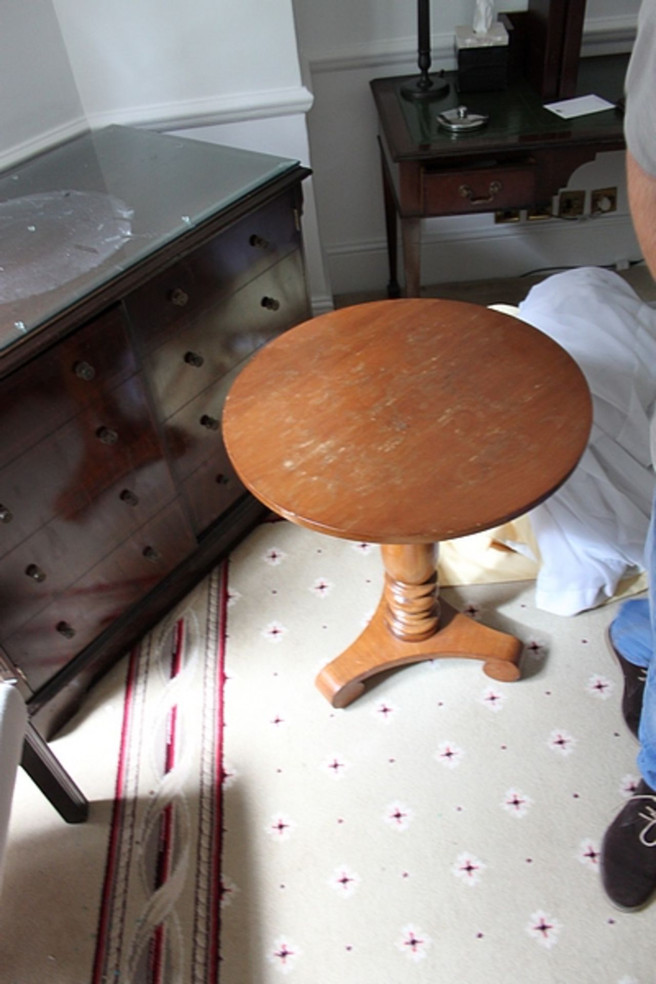 A pair of light mahogany circular top table on carved baluster column and raised on a tri-form