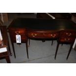 A mahogany Georigian style writing desk tooled leather inlay top bow fronted above a single centre