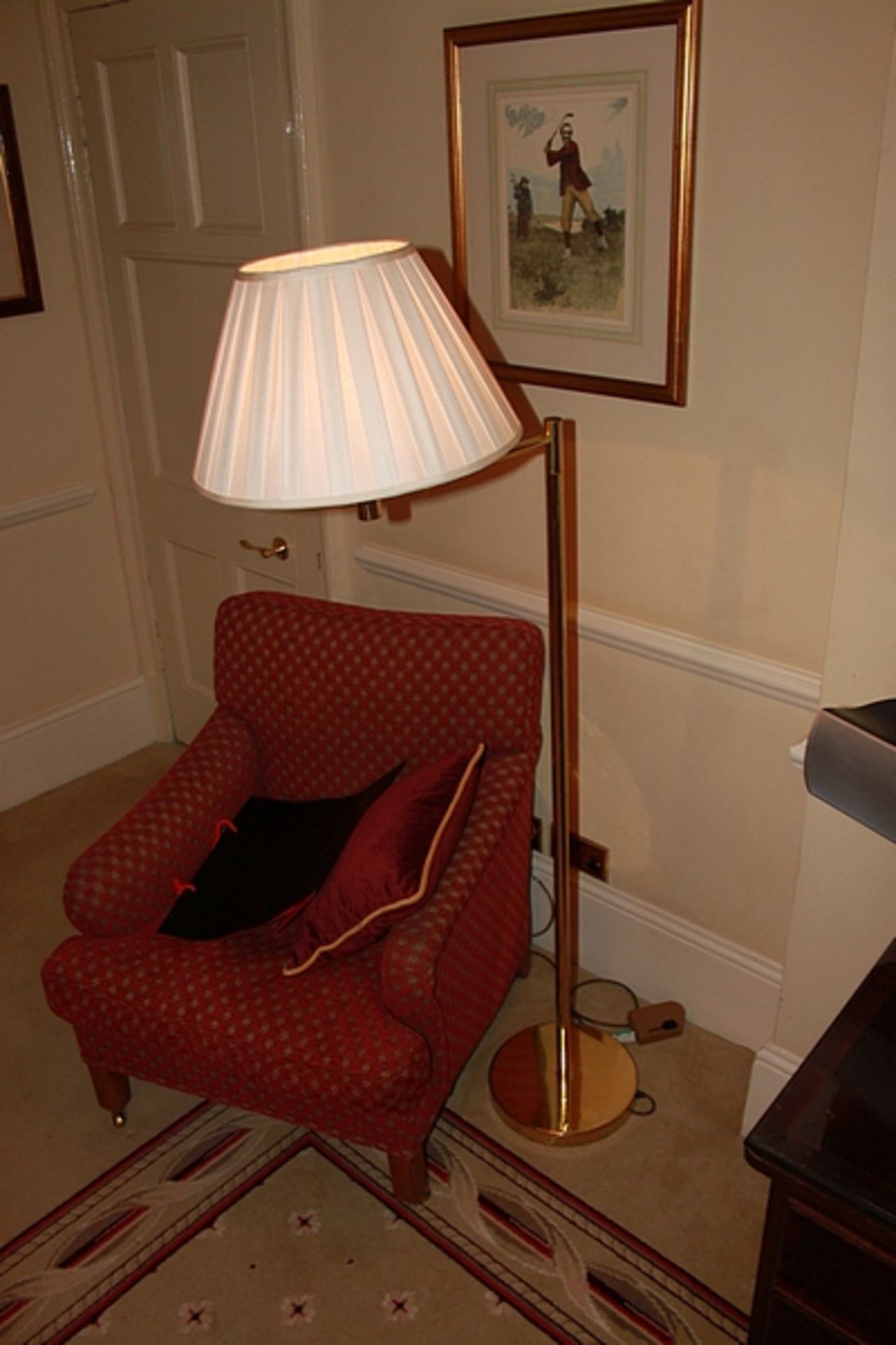 A floor standard lamp finished in brass