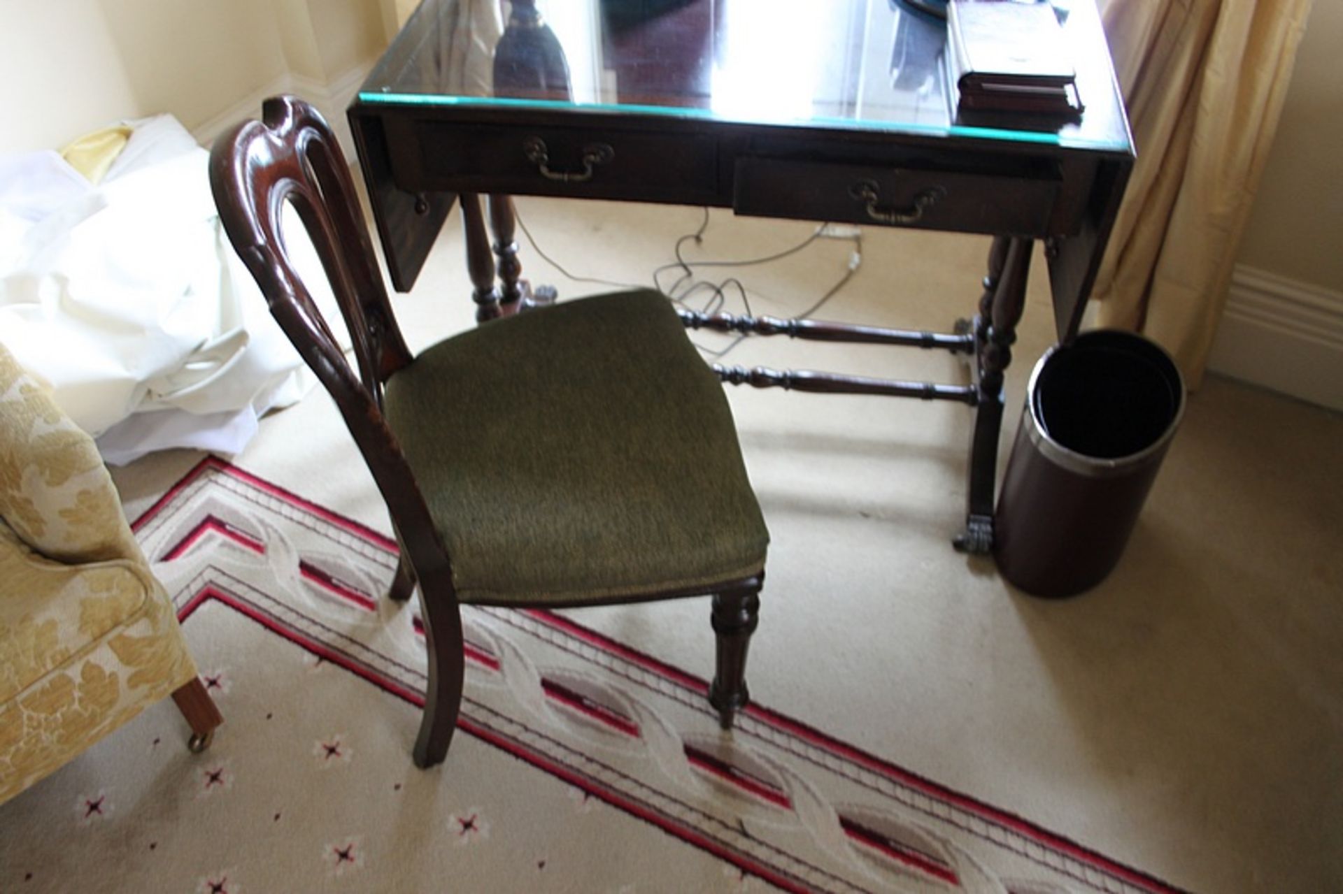 A mahogany side chair with a sage green pad seat carved back splat rest