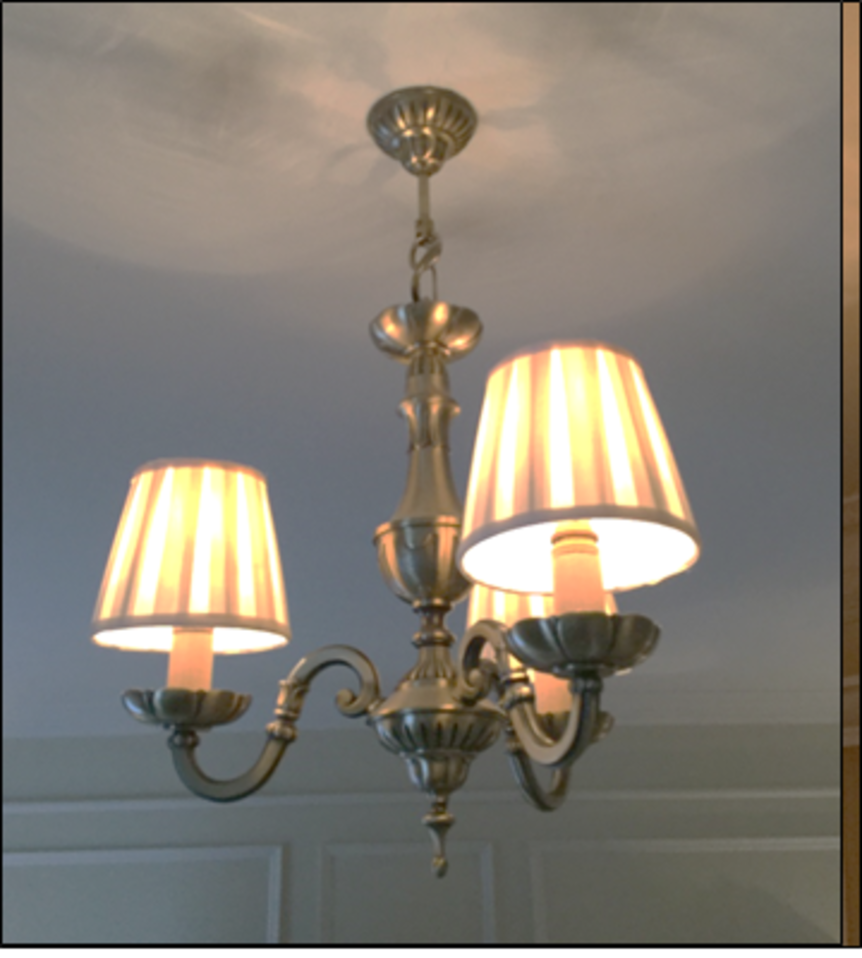 A 3 light antique brass finish chandelier