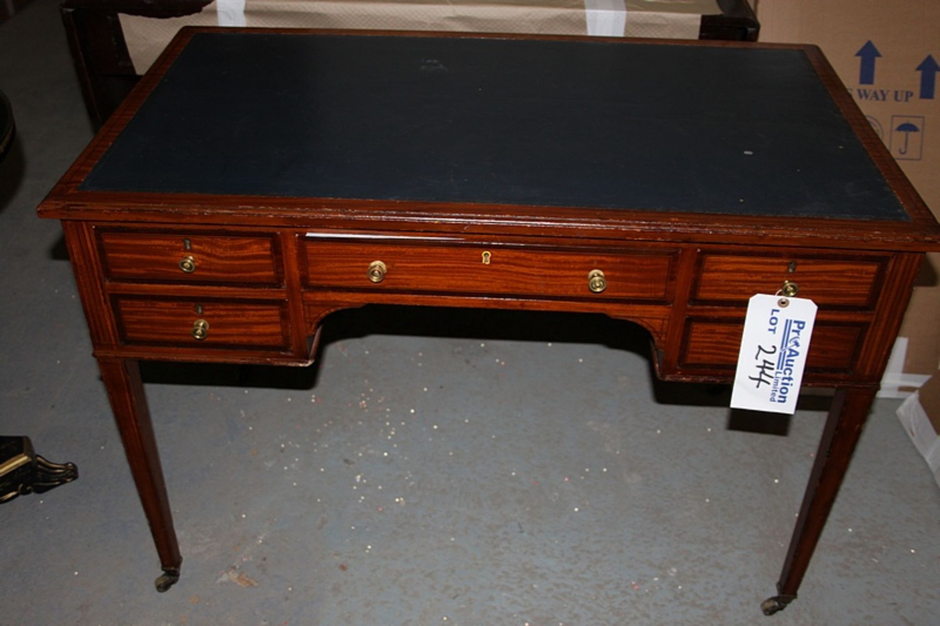 A Georgian style mahogany writing desk with tooled leather inlay top centre drawer flanked by two