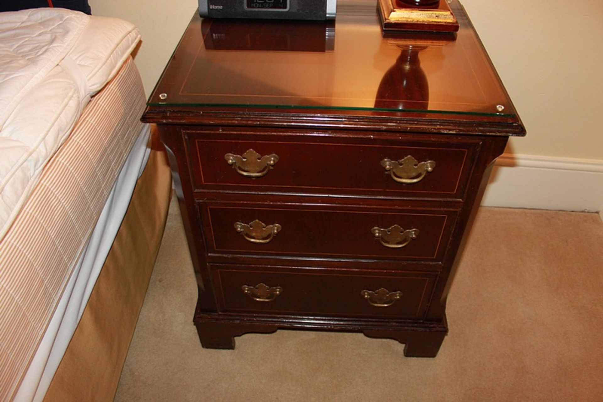 A mahogany bedside cabinet chests in the Georgian style three drawers below, of dovetail