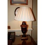 A large polished wood urn shape table lamp and shade