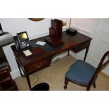 A mahogany Georgian style writing table featuring a leather top above two drawers supported by