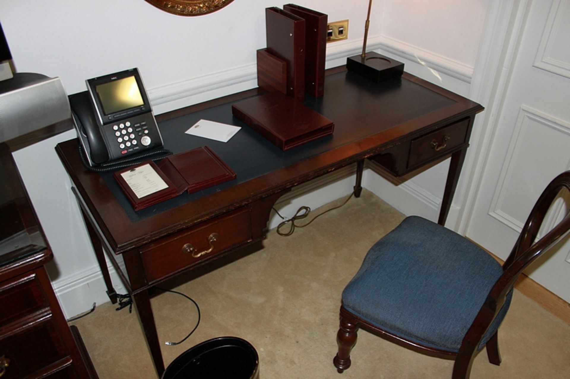 A mahogany Georgian style writing table featuring a leather top above two drawers supported by