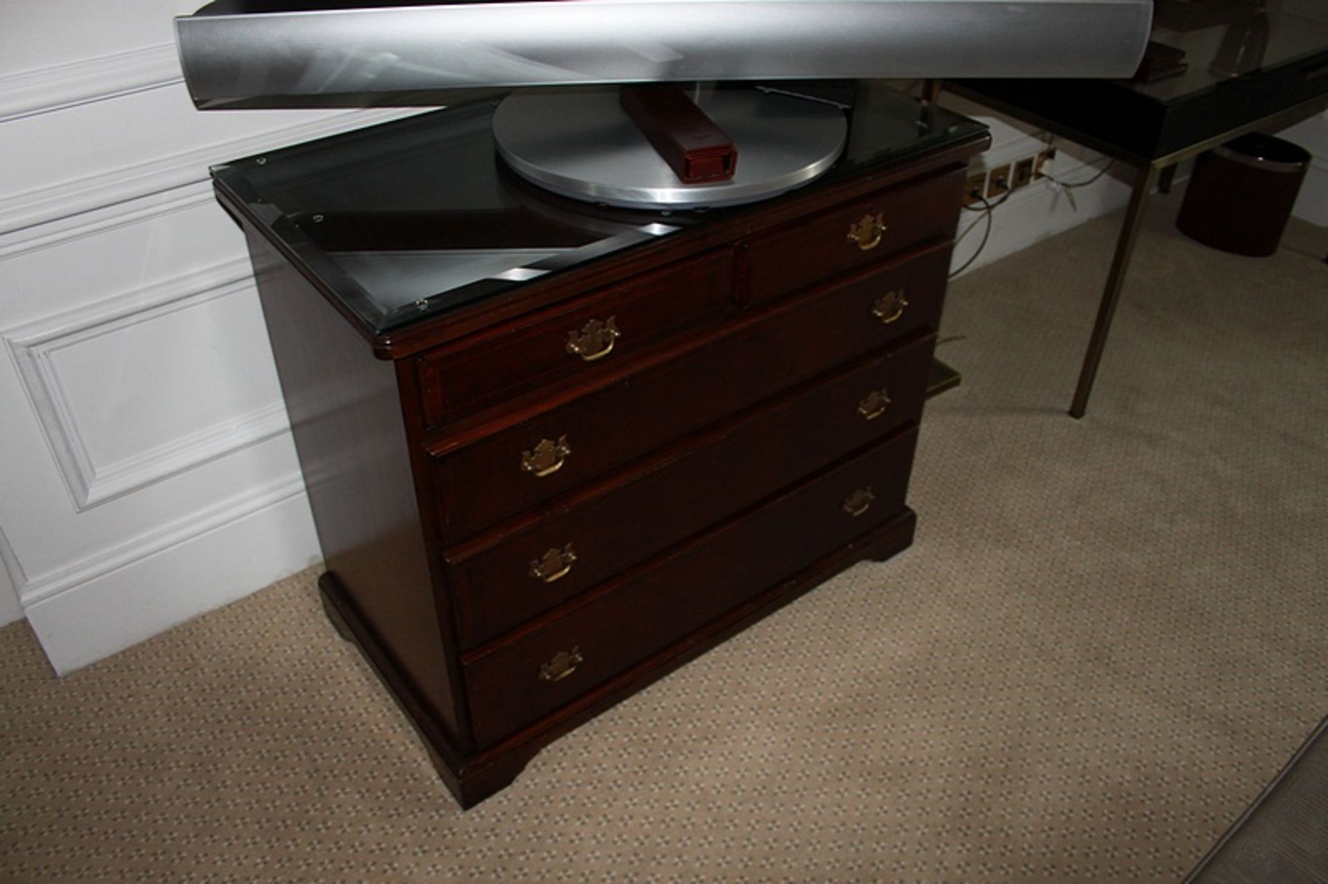 A Georgian style mahogany chest of drawers with three full and two half drawers on bracket plinth