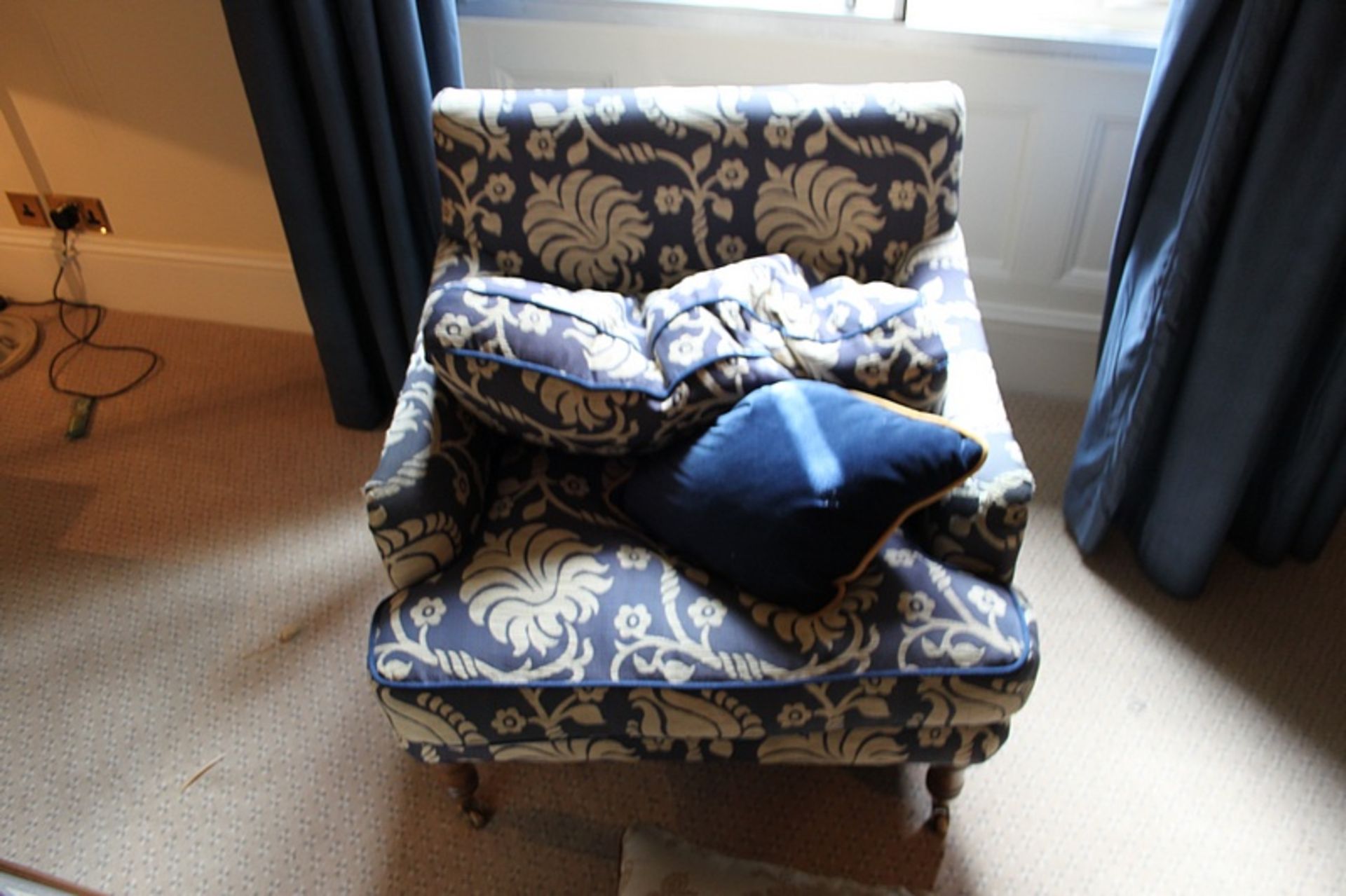 A pair of armchairs upholstered in blue fabric casters to front 700mm x 800mm