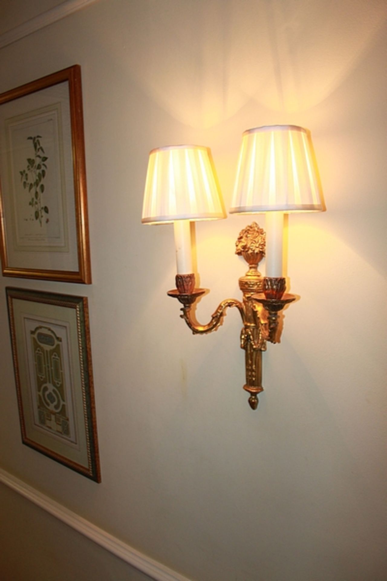 A pair of Georgian styled twin arm wall sconces