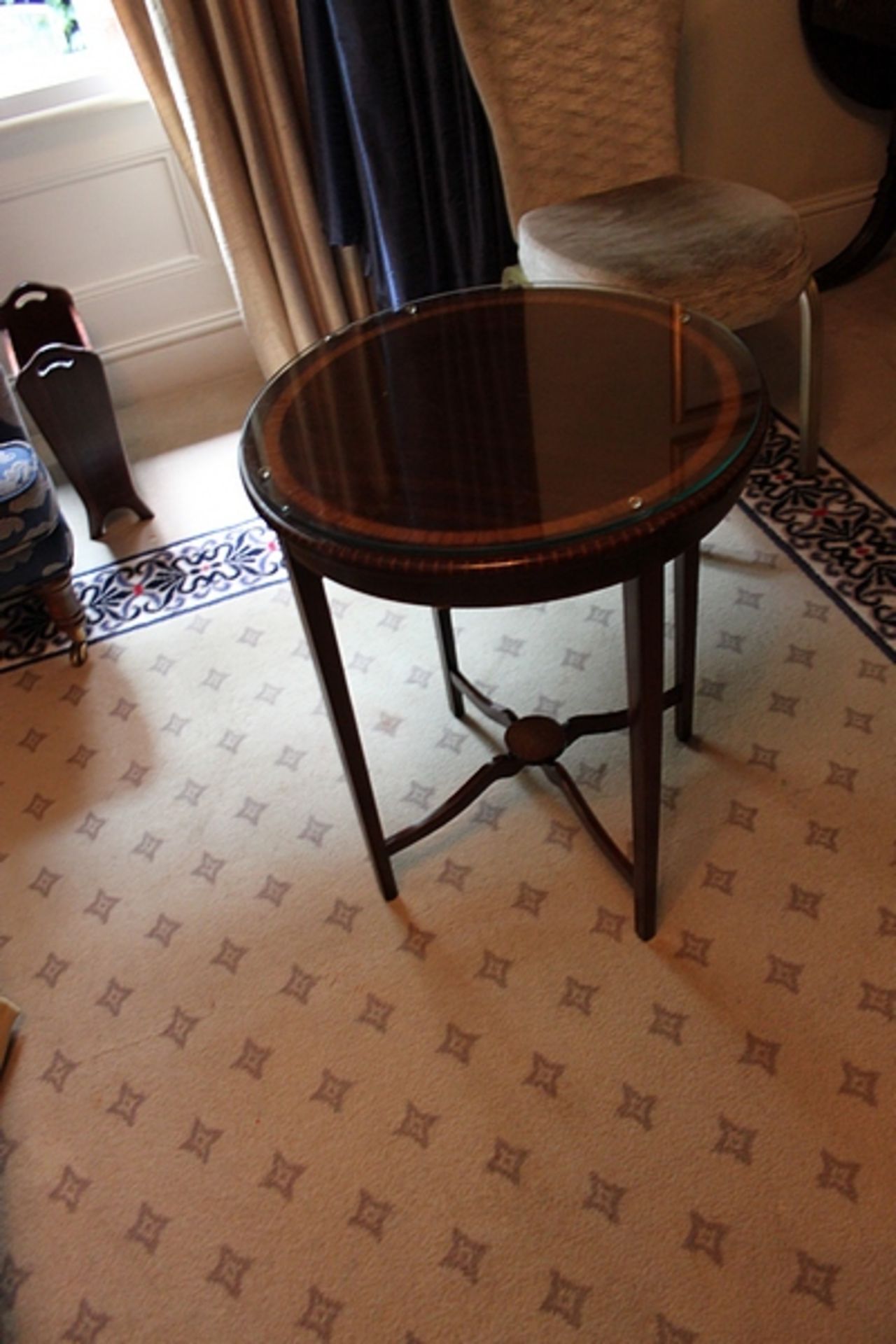 A mahogany 600mm circular side table carved pron mounted on turned legs