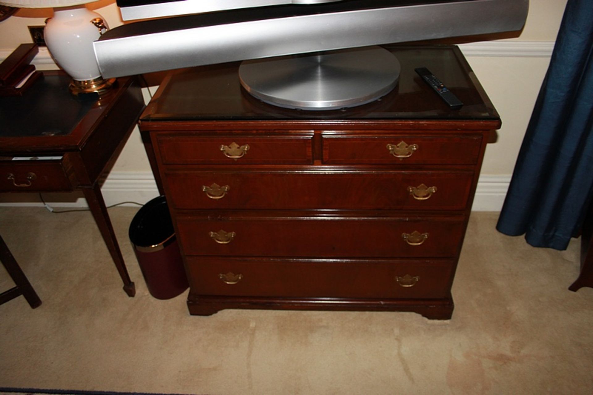 A Georgian style mahogany chest of drawers with three full and two half drawers on bracket plinth