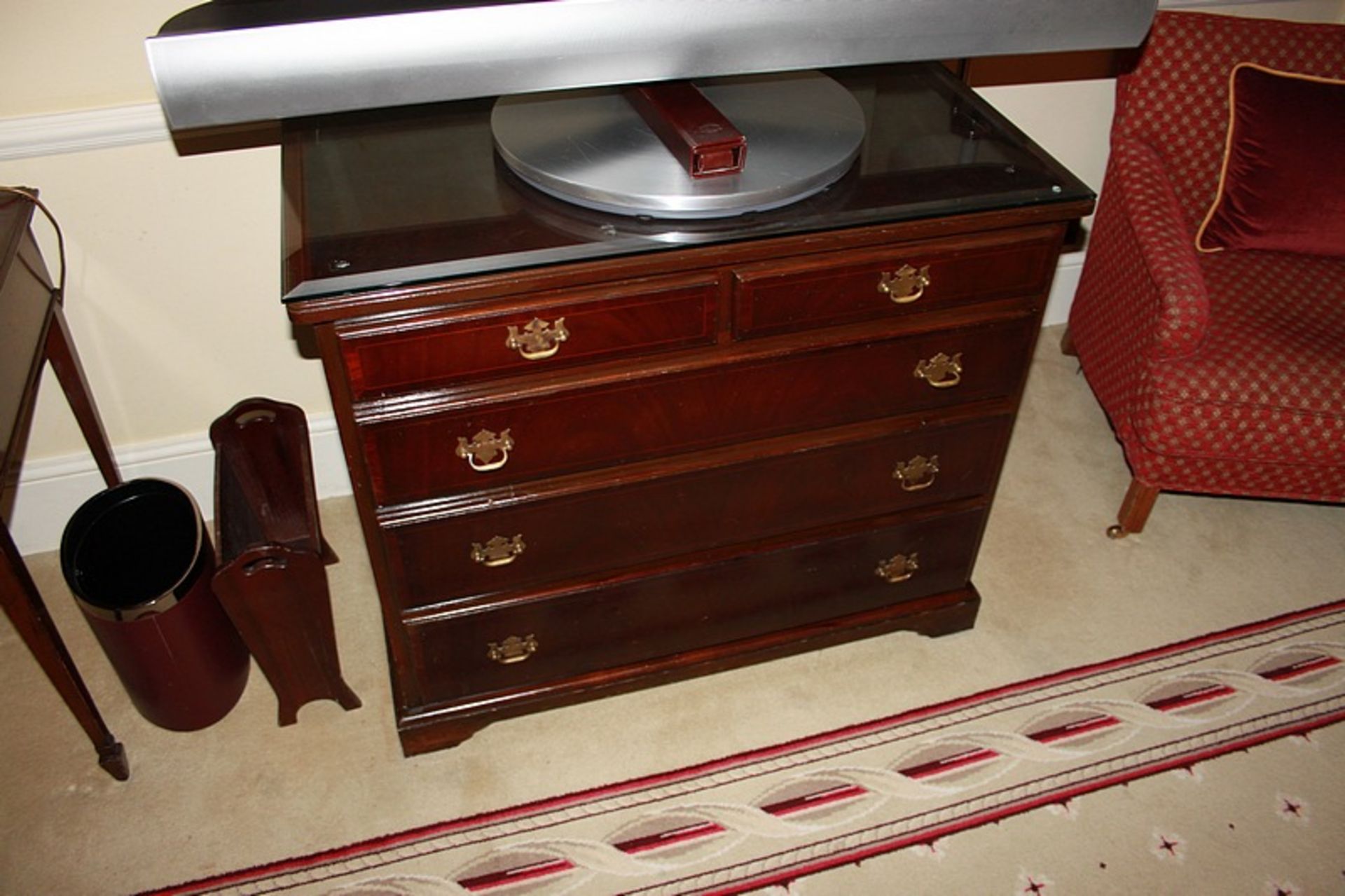 A Georgian style mahogany chest of drawers with three full and two half drawers on bracket plinth