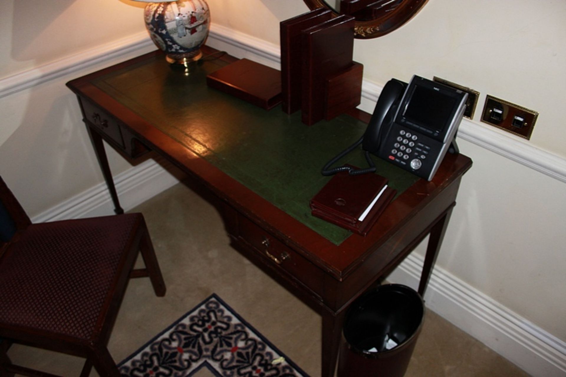 A mahogany free standing inlay writing desk kneehole with two graduated drawers to each side mounted