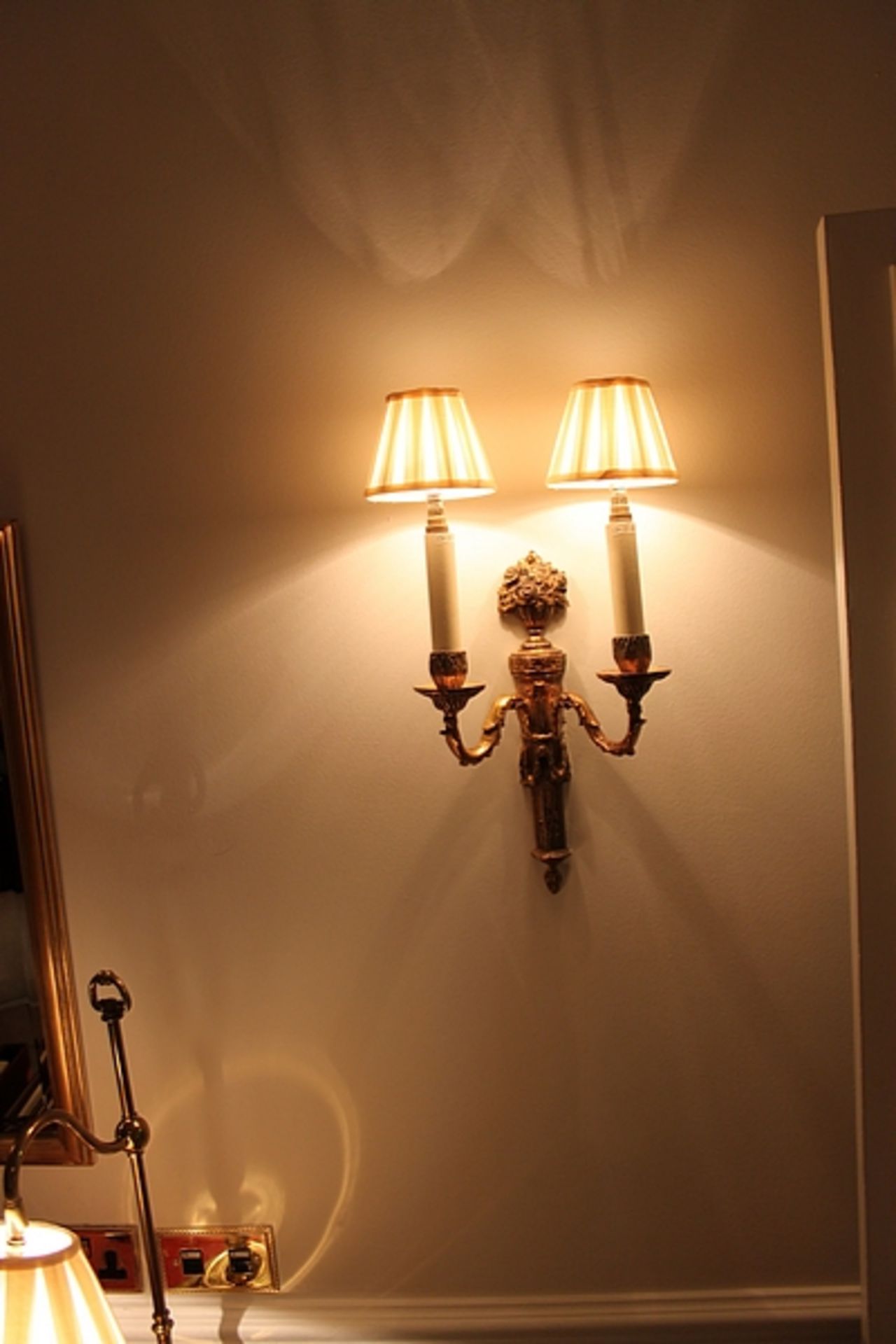 A pair of Georgian styled twin arm wall sconces