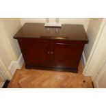 A mahogany moulded top two door side cabinet the door panel reveals internally fitted with two