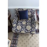A pair of traditional easy armchair upholstered in a blue broccade fabric casters to front 700 x