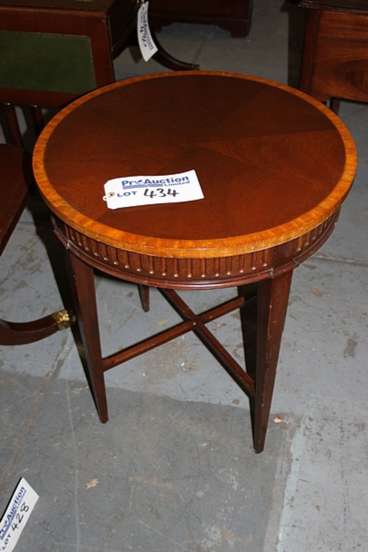 A mahogany circular occasstional tablewith deep apron and mounted with low stretcher