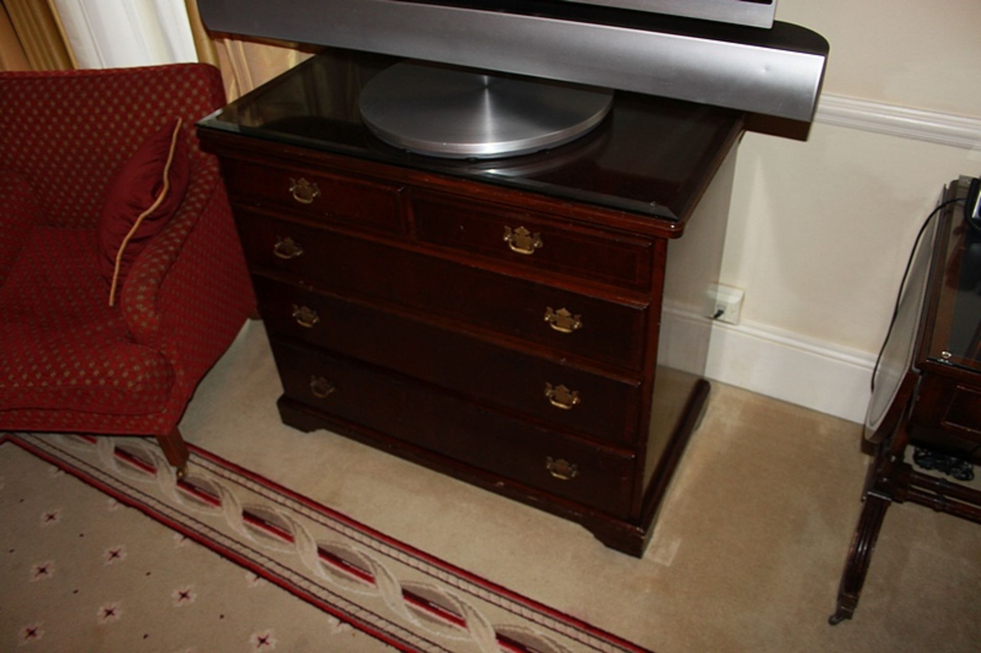 A Georgian style mahogany chest of drawers with three full and two half drawers on bracket plinth