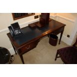 A mahogany Georgian style writing table featuring a leather top above two drawers supported by