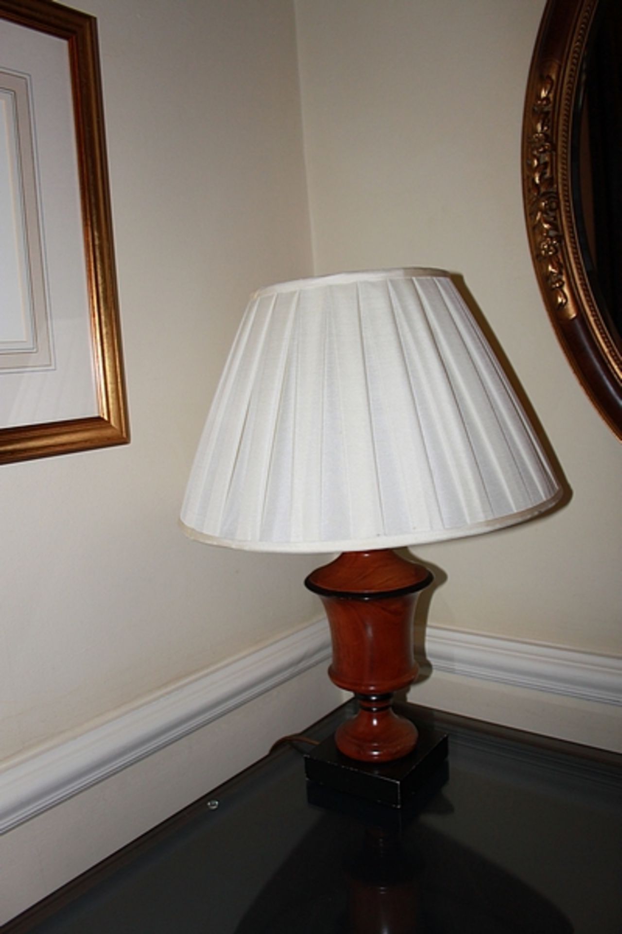 A pair of polished wood urn shape table lamp and shade