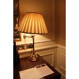 A brass swivel arm table lamp