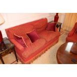 A two seater sofa upholstered in red fabric with repeating red check pattern 1650mm x 800mm