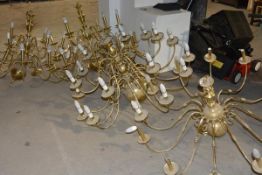 A group of four large brass multi-branch chandeliers in the Dutch Baroque taste, 20th century.