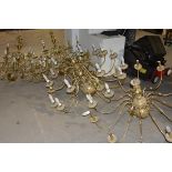 A group of four large brass multi-branch chandeliers in the Dutch Baroque taste, 20th century.