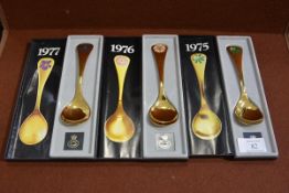 A group of three Georg Jensen silver gilt and enamel year spoons, 1975, 1976 and 1977, each in