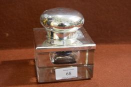 A large Edwardian silver-mounted glass desk inkwell, London 1909, of square form with hinged