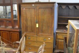 A George III mahogany linen press, the moulded cornice above a pair of panelled doors enclosing