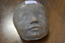 A 19th century plaster mask of a child