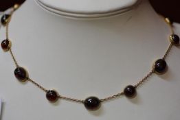 A 9ct gold chain link necklace mounted fourteen graduated oval and circular cabochon alternating