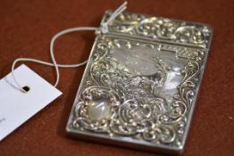 An Edwardian silver card case, Crisford & Norris, Birmingham 1907, decorated with a stag amidst