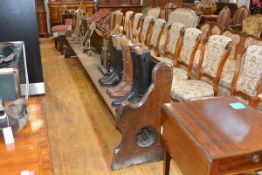 A large late 19th century oak church pew, with panelled back and Gothic pierced ends. 396cm