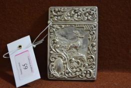 An Edwardian silver card case, Crisford & Norris, Birmingham 1904, decorated with a stag amidst