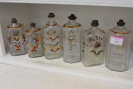 A group of early 19th century German enamel painted glass bottles, of varying shapes, each with