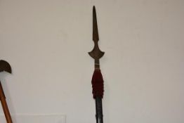 A partisan in 18th century style, with crescentic steel blade on a faceted studded wooden shaft,