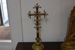 A 19th century brass and enamel crucifix, in the Gothic taste, the cross set with ruby glass