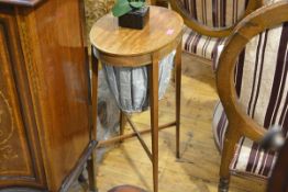 An Edwardian mahogany work table in the George III taste, the oval top above a frieze drawer and