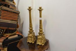A pair of brass altar sticks in 18th century style, each with leaf-cast fluted column on scroll