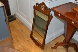 A George III parcel gilt fretwork mirror, with ho ho bird crest over a rectangular plate within a