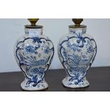 A pair of 19th century Delft vases, mounted as lamps, each of baluster form, painted in blue with