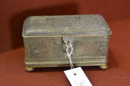 A 19th century Indo-Persian brass casket, the hinged cover and body densely decorated in relief with