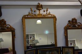 A George III style giltwood mirror, the rectangular plate within a frame with eagle and leaf