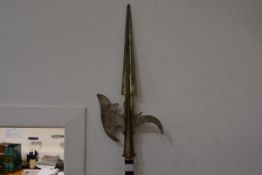 A Continental halberd in 17th century style, with ridged pointed spike above an engraved scroll-cast