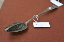 An 18th century silver basting spoon, maker's mark JP, the bowl with central strainer, fiddle