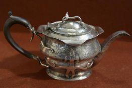 An Edwardian silver teapot in the Arts & Crafts taste, J. W. & Barrett & Sons, Birmigham 1903, of