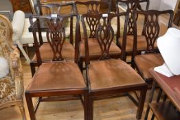 A set of seven George III style mahogany dining chairs, comprising six side chairs and one carver,